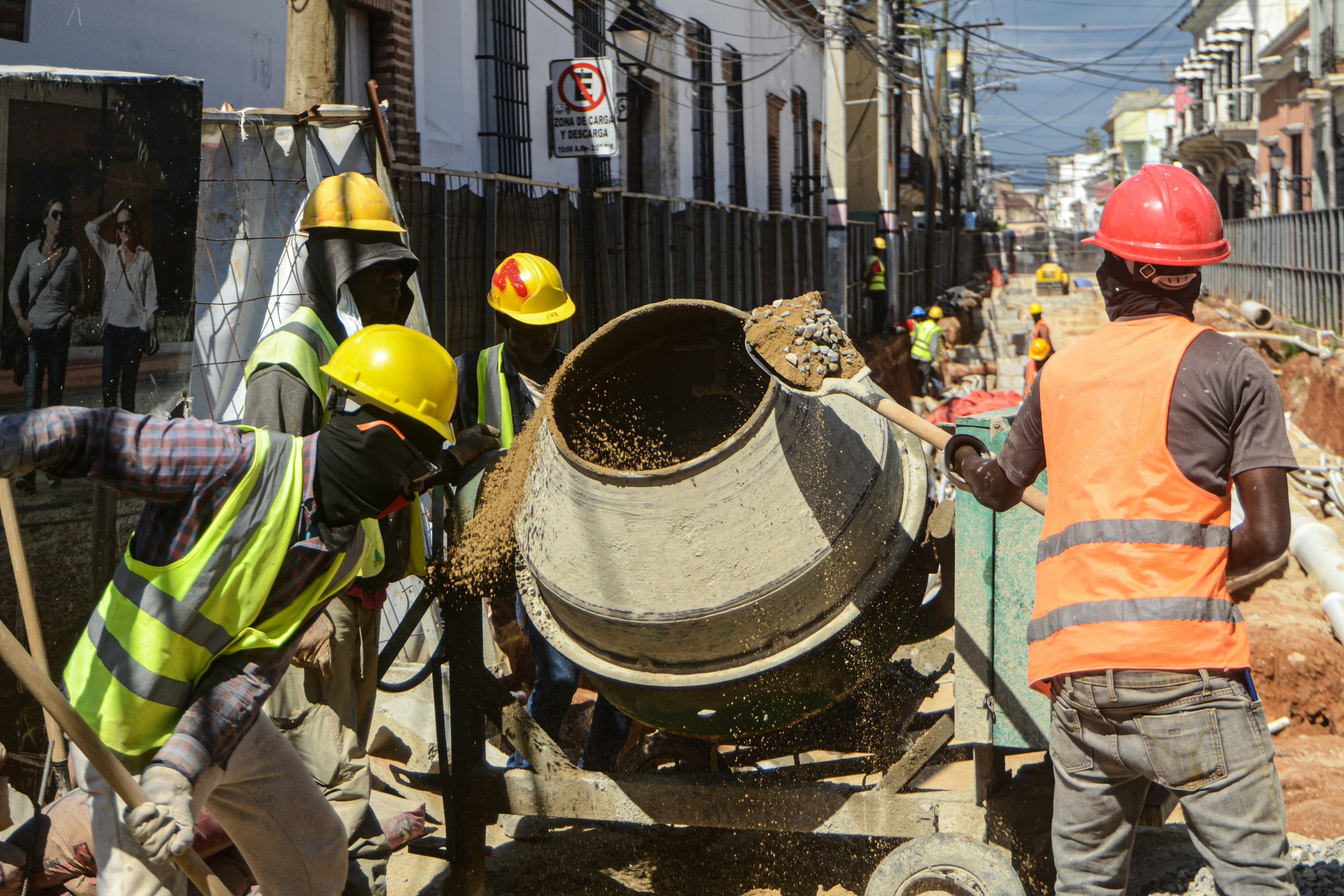 Concrete mixer actively batching and pouring on a construction site